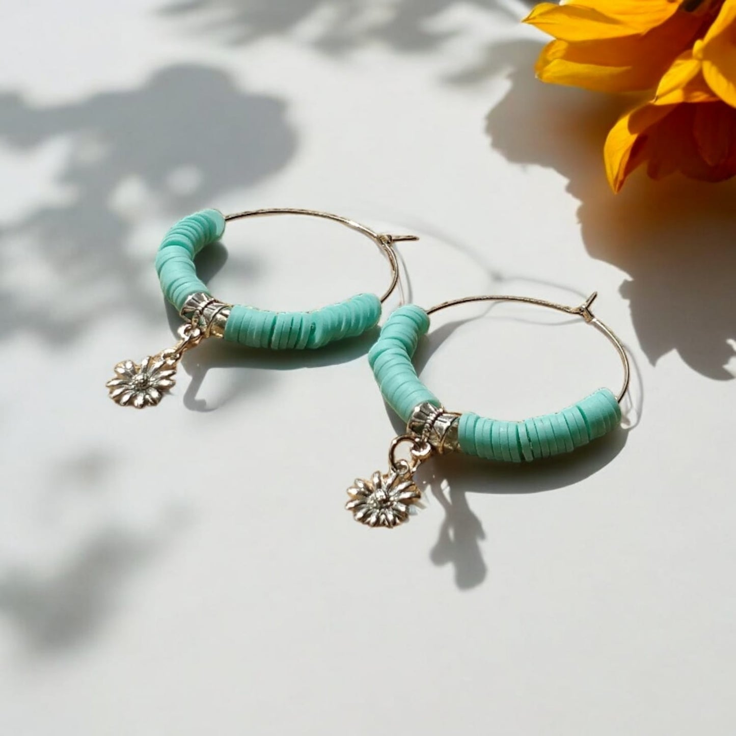 Hoop earrings with blue beads and charm