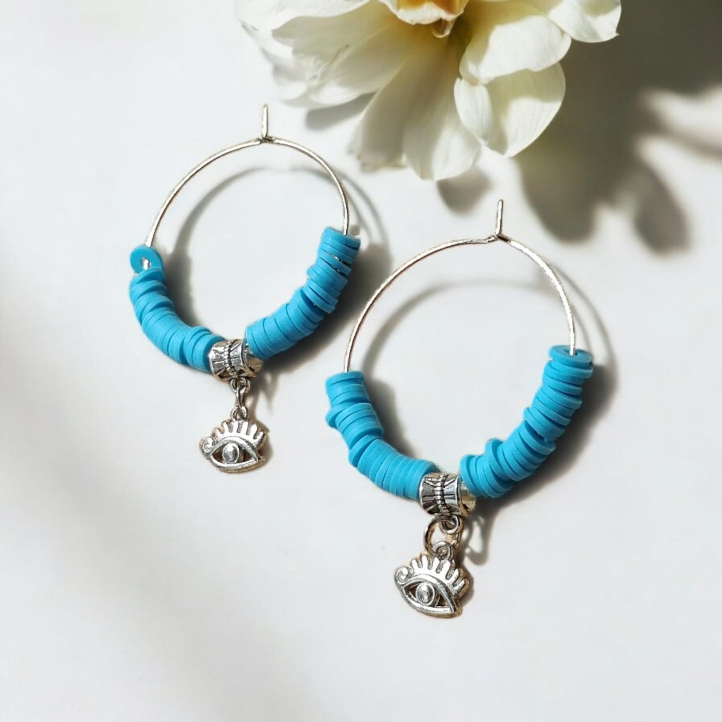 Hoop earrings with blue beads and charm of evil eye