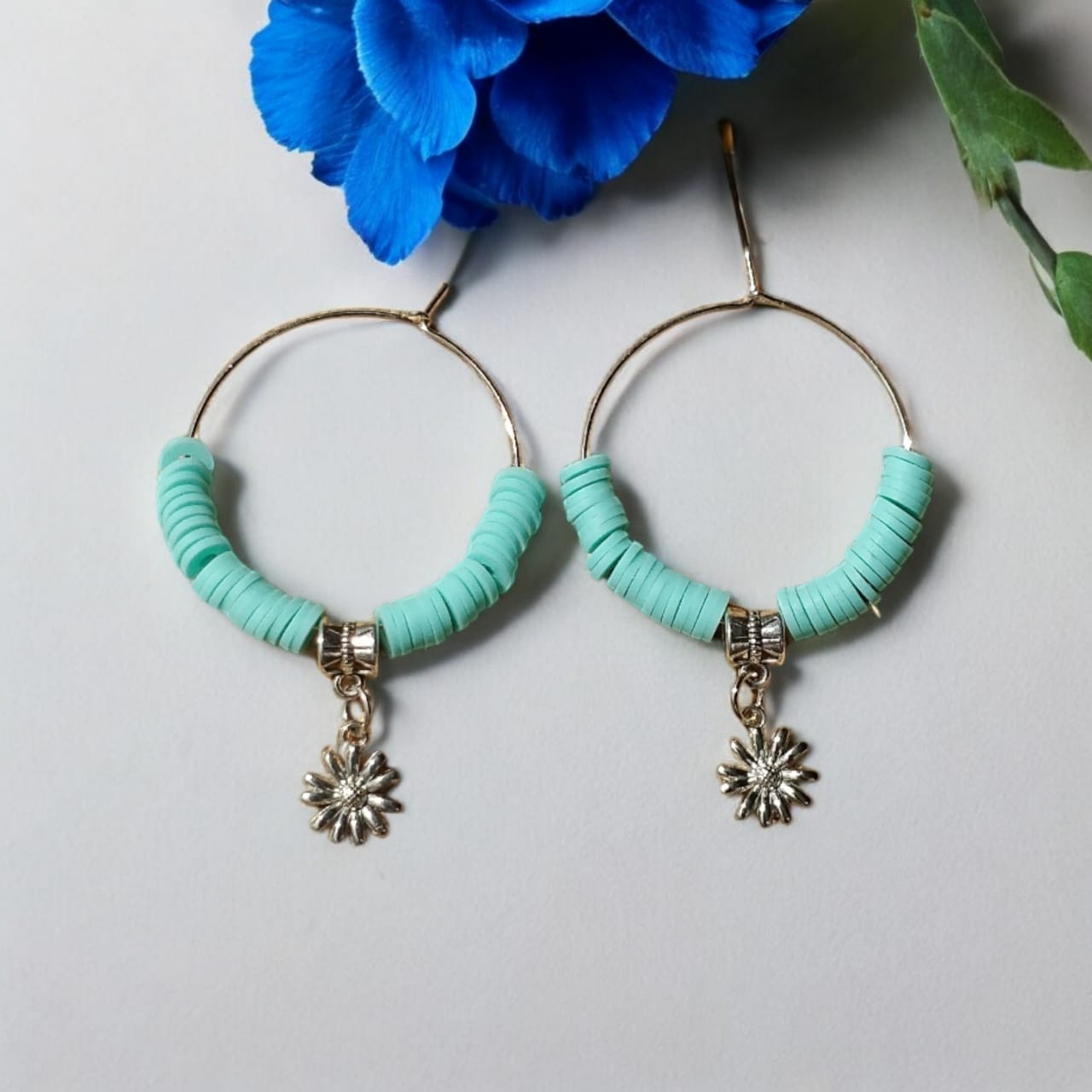 Hoop earrings with blue beads and charm