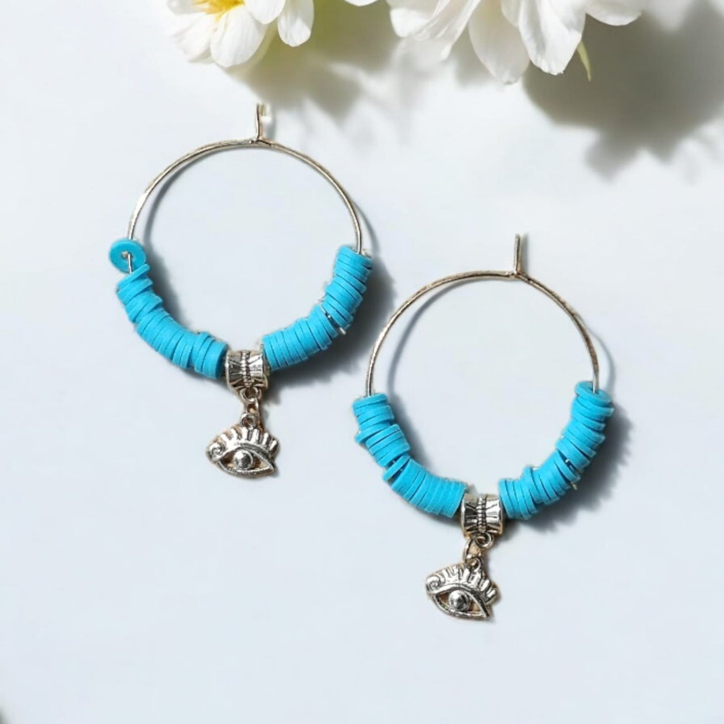 Hoop earrings with blue beads and charm of evil eye